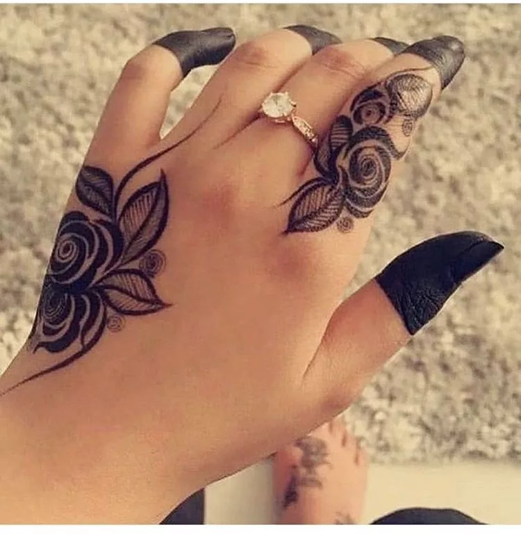 Beautiful female hands with henna tattoo on dark background Stock Photo -  Alamy